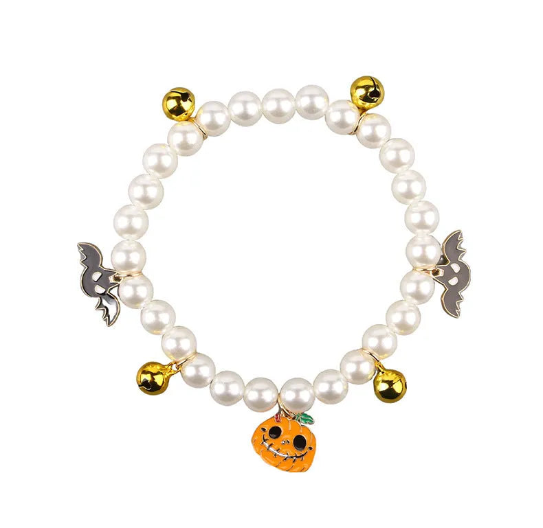 Halloween cat collar decoration with simulated pearls in purple ghost, skull, and smiling pumpkin designs.