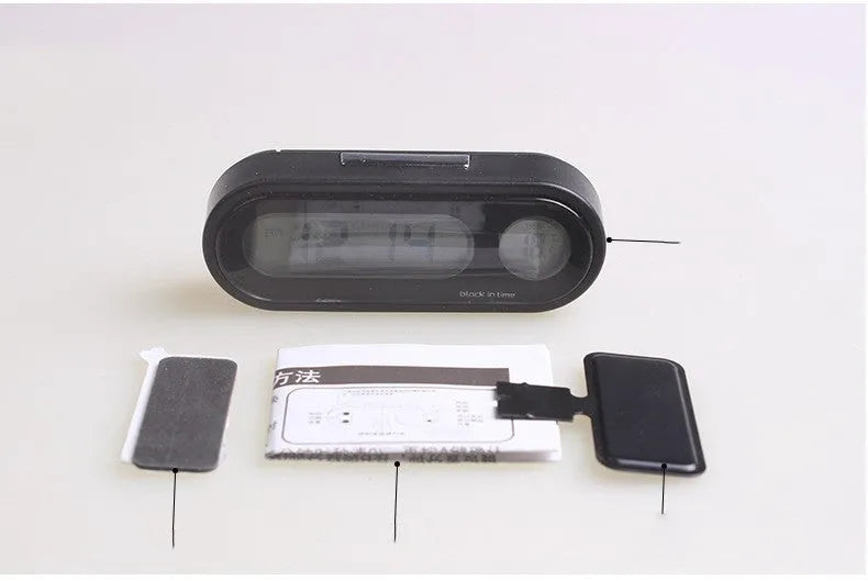 Black electronic car dashboard clock and thermometer unit with digital LED display on an adjustable bracket.