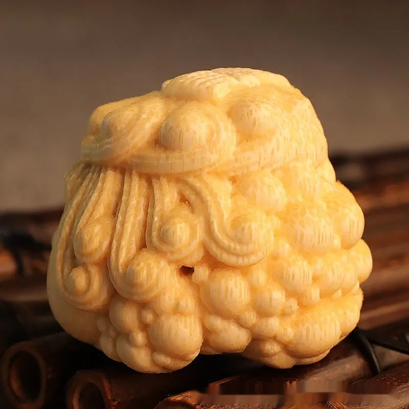 Solid bamboo carved golden toad princess ornament on display.
