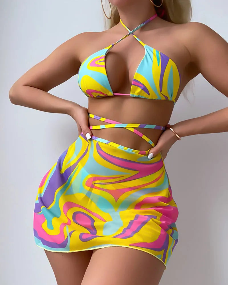 Yellow striped halter swimsuit for women with lace-up front, matching skirt, and shorts.