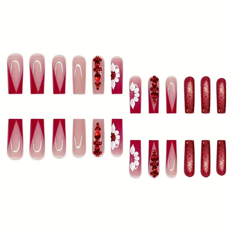 Sweet floral pattern fake nails with prismatic red diamond finish on long European square shape.