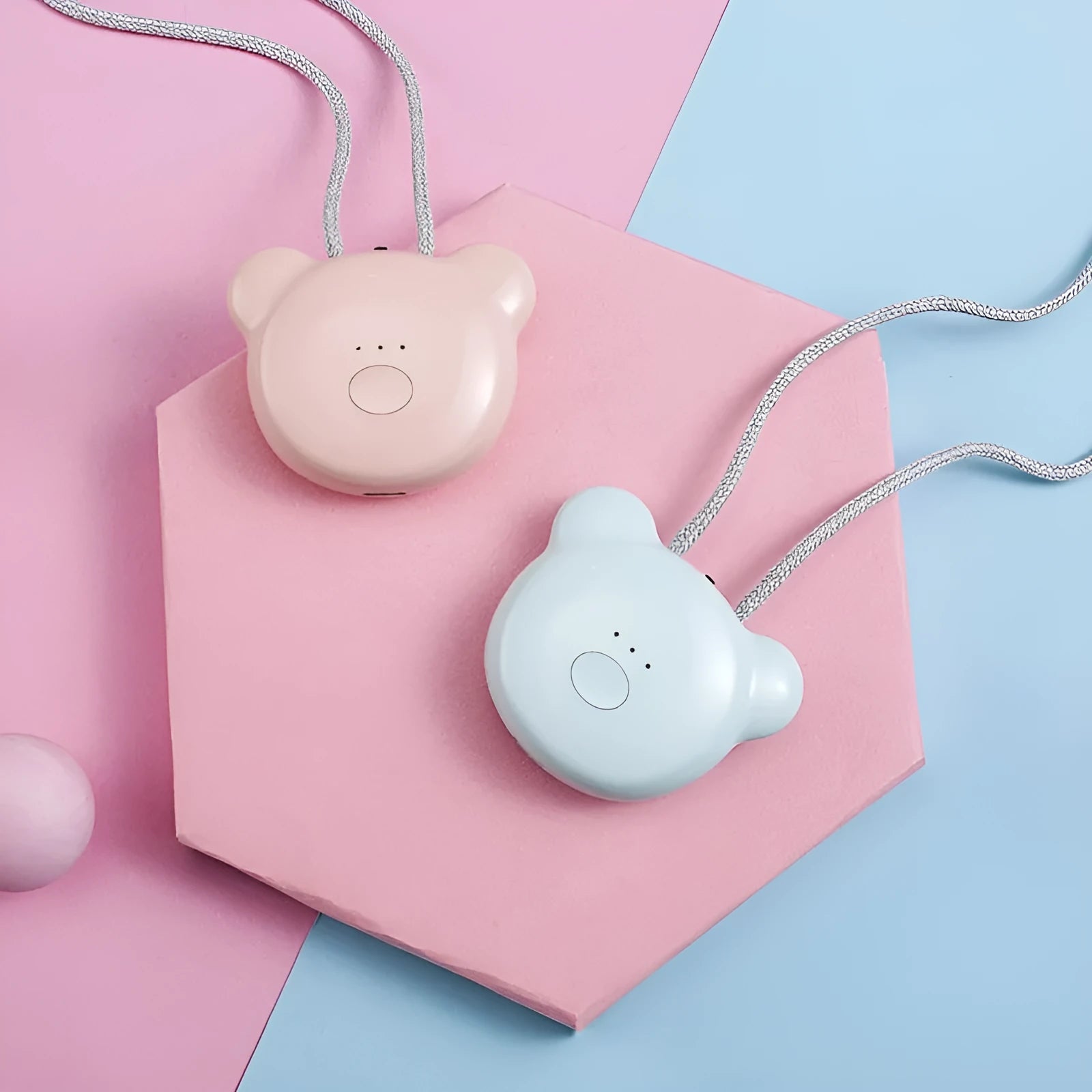 Mini USB air purifier pendant on a necklace, shown in pink colour with charging cable.