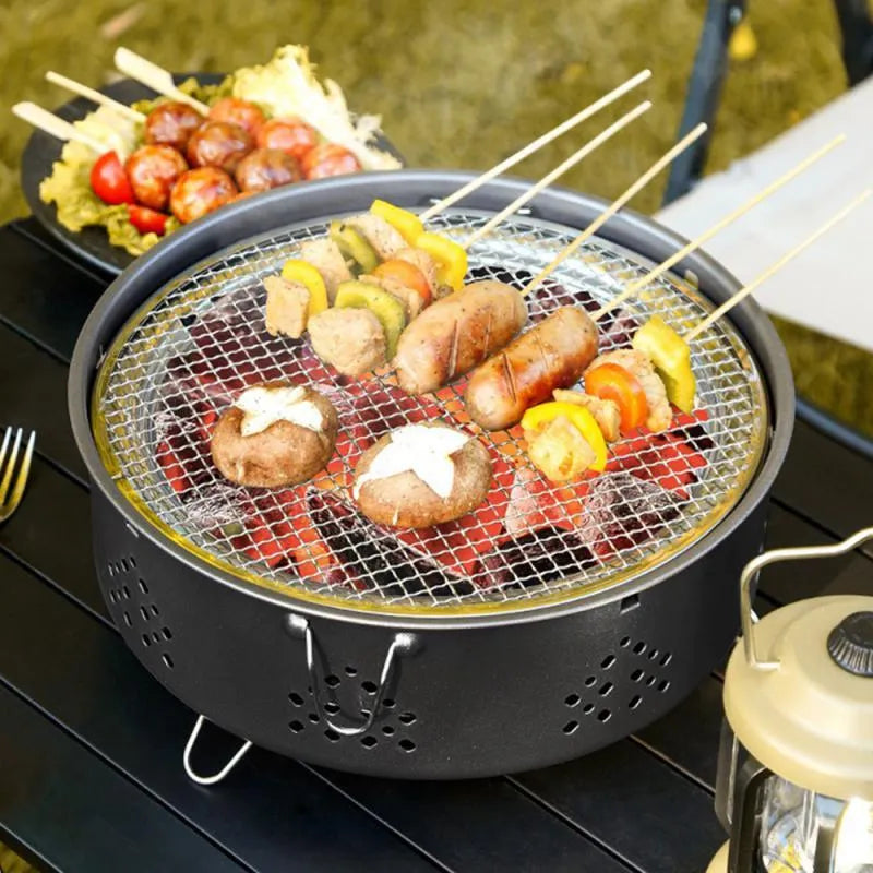 Portable stainless steel barbecue grill with detachable design and storage bag for camping.