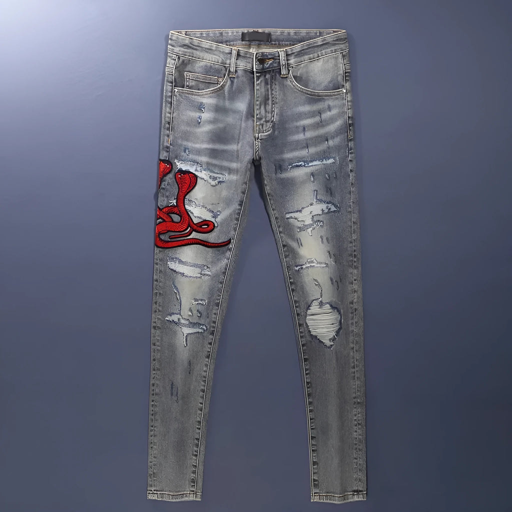 Slim fit jeans in washed-out old colour with patch embroidery detail on the leg.