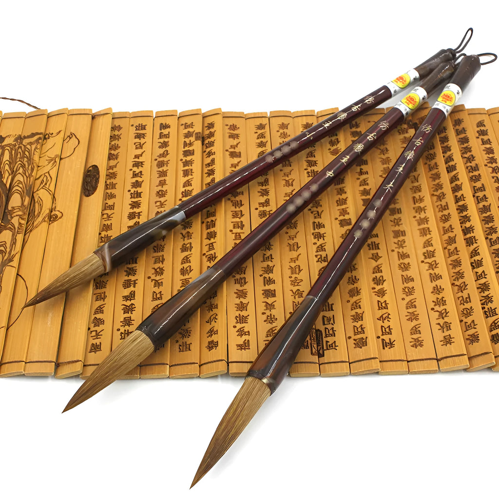 Traditional Chinese wolf hair calligraphy brushes with steel rod handles in large, medium, small, and trumpet sizes.
