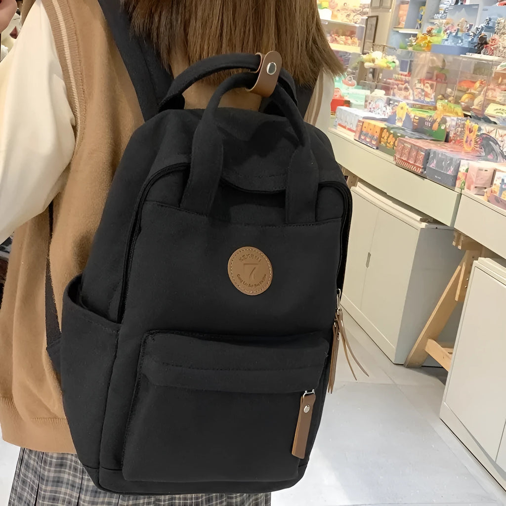 Black Oxford cloth backpack with curved shoulder straps for school and travel