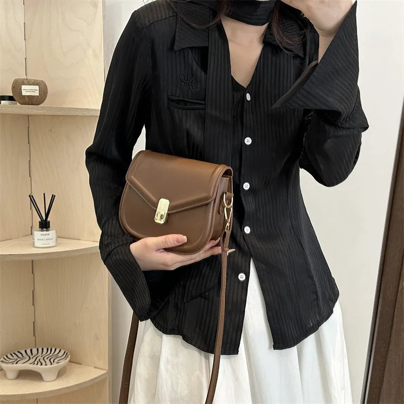 Soft, textured PU clamshell messenger bag in a horizontal rectangle shape.