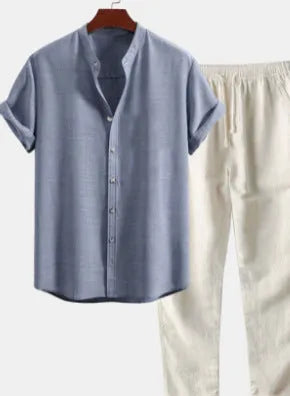Man wearing a loose-fit linen-blend short sleeve shirt and matching casual trousers from a co-ord suit set.