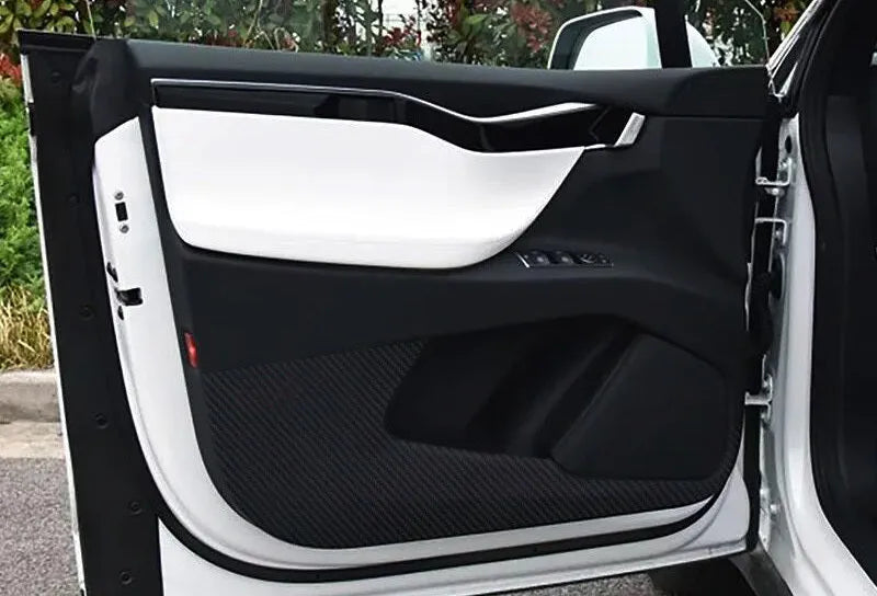 Four carbon fibre protective film pieces for Tesla Model S interior door panels.