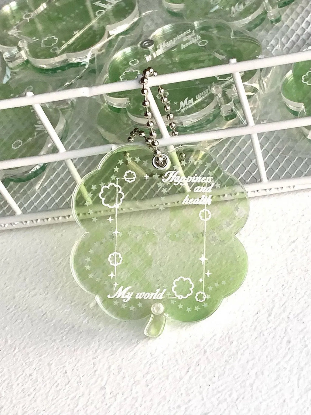 Lucky four-leaf clover shaped acrylic pendant keychain in blue, green, or mint green colours.