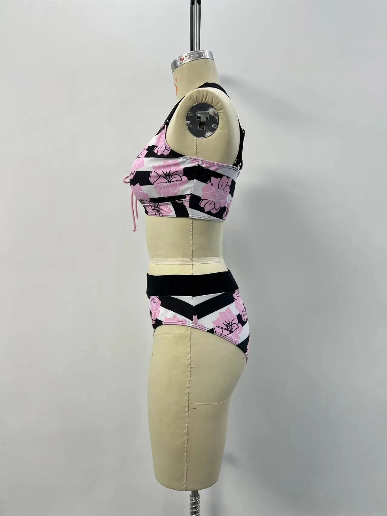 Black women's two-piece bikini swimsuit with printed belly cover design.