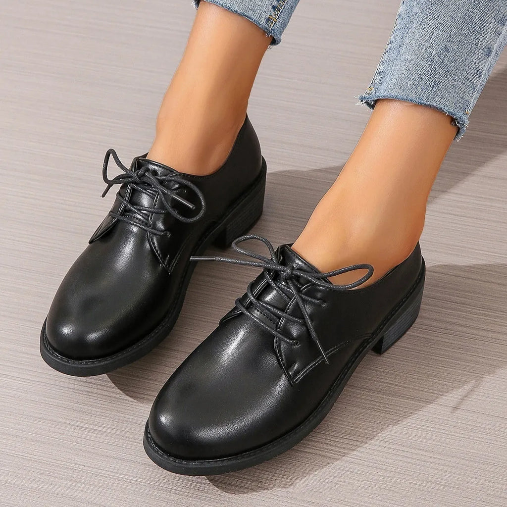 Black women's low-top PU leather shoes with a chunky mid-heel and pointed toe.