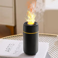 Car aroma diffuser with simulated flame effect showing black unit with mist output