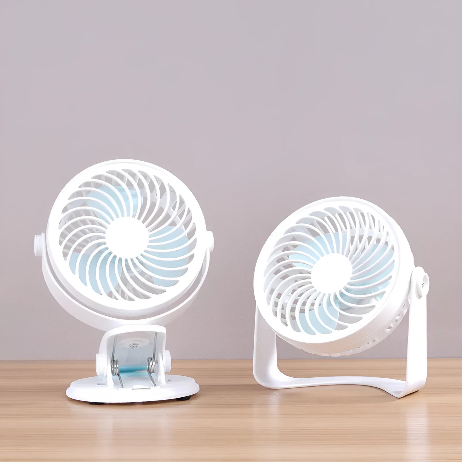 Small white USB desk fan with three blades, shown both clipped to a surface and standing on a desk.