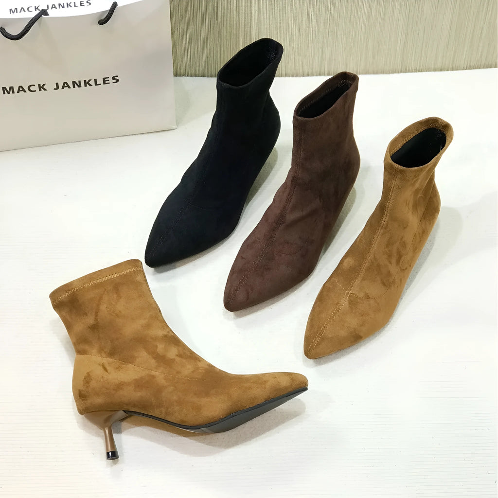 Women's black pointed toe ankle boots with stiletto heel and mid-calf length