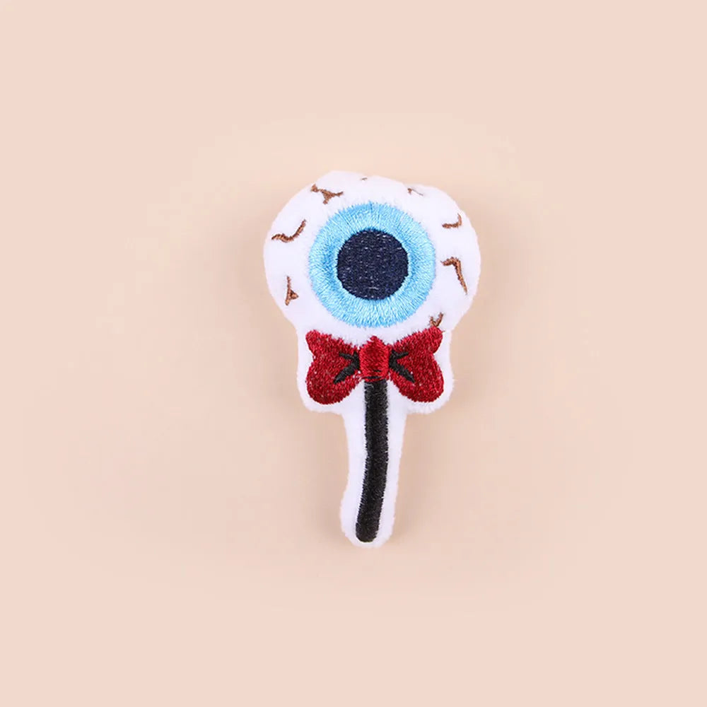 Small plush cat teaser toy with colourful candy or skull design on string