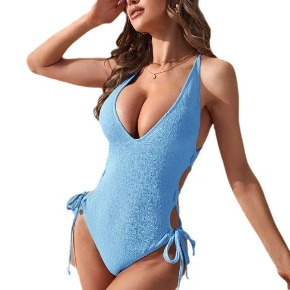 Women's black hollow backless one-piece swimsuit with tether detail on a mannequin