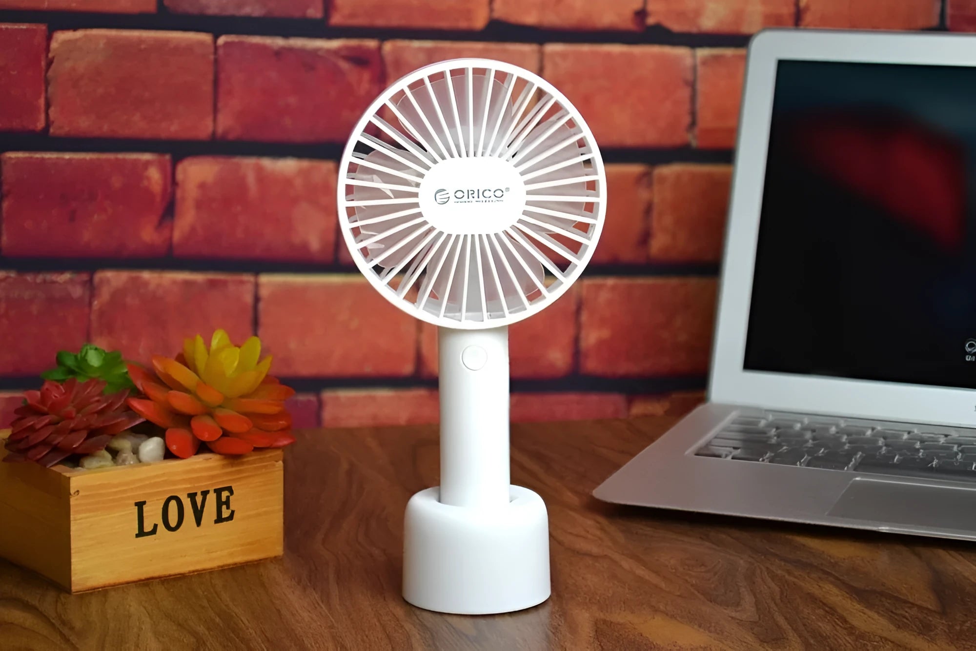 White ORICO FH1 USB rechargeable portable handheld and desktop fan with fine-line detailing.