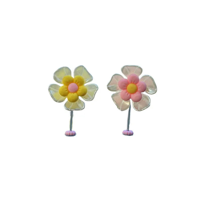 Small colourful plastic swing decoration for car interior, approx. 5cm tall.
