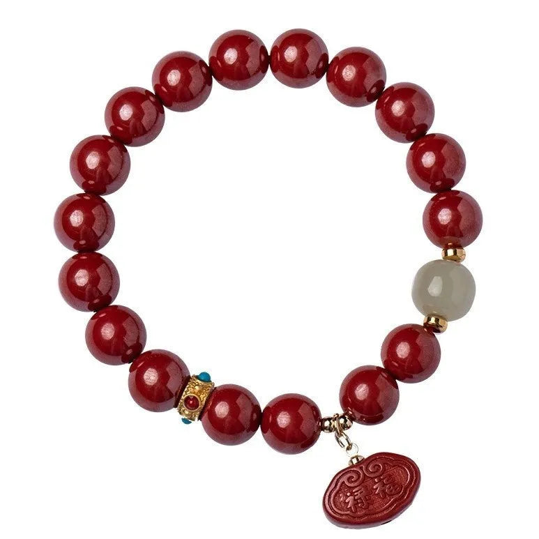 Natural cinnabar Emperor Sandstone Ping An Fu Lu bracelet with red beads.