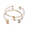 Gold electroplated alloy women's cuff bracelet with vintage arrow and knot design.