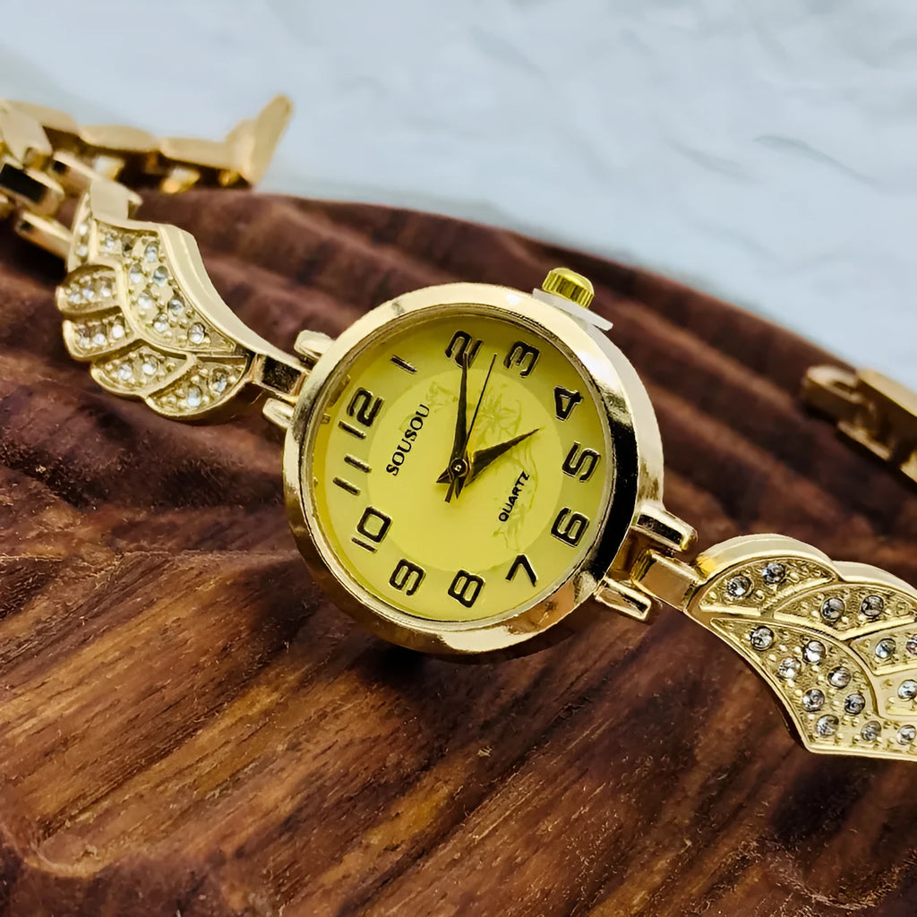 Women's stainless steel watch with round dial on wrist, showing gold face colour option and vachette clasp.