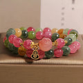 Natural jade colour tourmaline crystal double ring bracelet for women with Buddha head charm on white background
