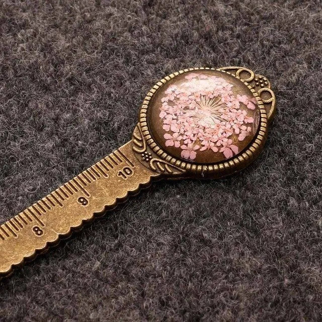 Handmade dried flower bookmark with ruler showing lace flowers, daffodils, and clover at 12cm length