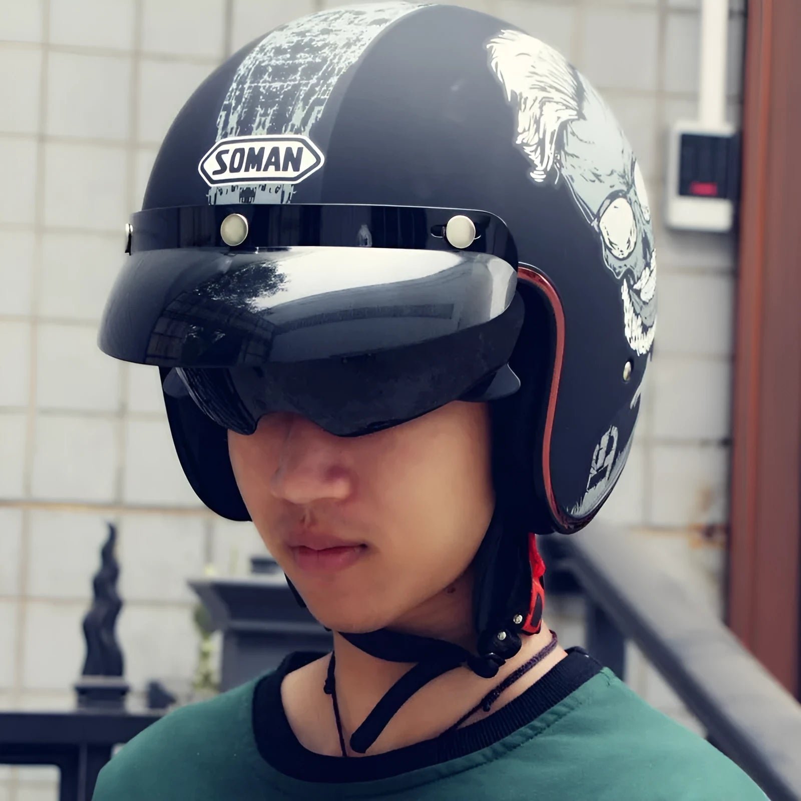 Retro-style black and orange open-face motorcycle half helmet for adults on a white background.