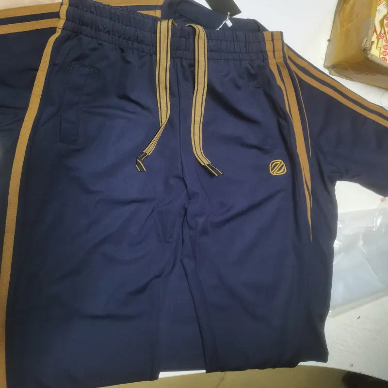 Man wearing a blue short sleeve suit top and trousers, showing the sportswear style
