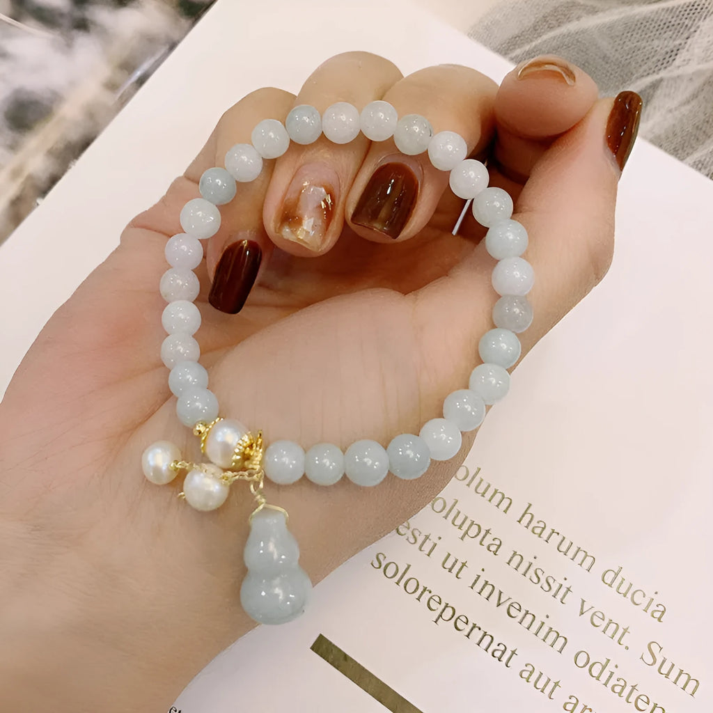 Chinese style jade bracelet with gourd design featuring natural emerald stone and pearl accents