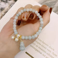 Chinese style jade bracelet with gourd design featuring natural emerald stone and pearl accents