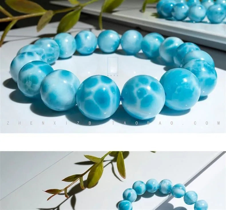 Blue and natural toned bodhi bracelet with a sea-pattern crystal stone centre and pearl accent.