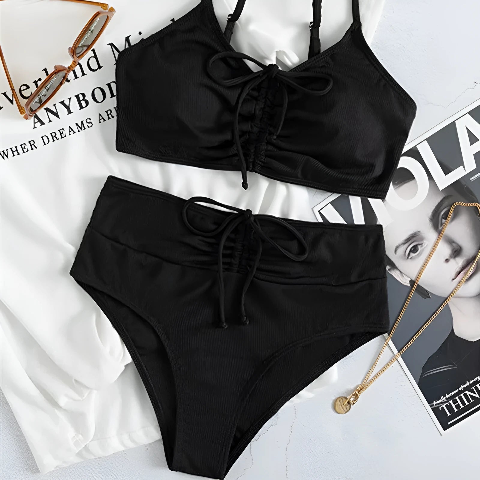 Black women's swimsuit set with sling bikini top and high-waist shorts with side splits