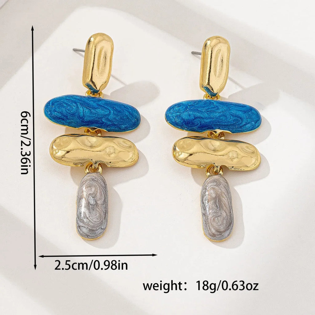 Gold-electroplated zinc alloy geometric stud earrings on a plain background.