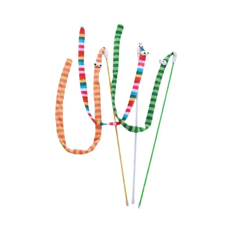 A colourful cat teaser wand with a long plush strip and a bell, held by a person.