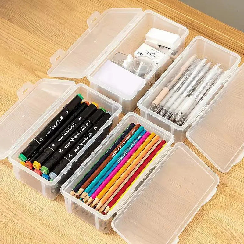 Transparent plastic storage box containing coloured pencils and drawing materials
