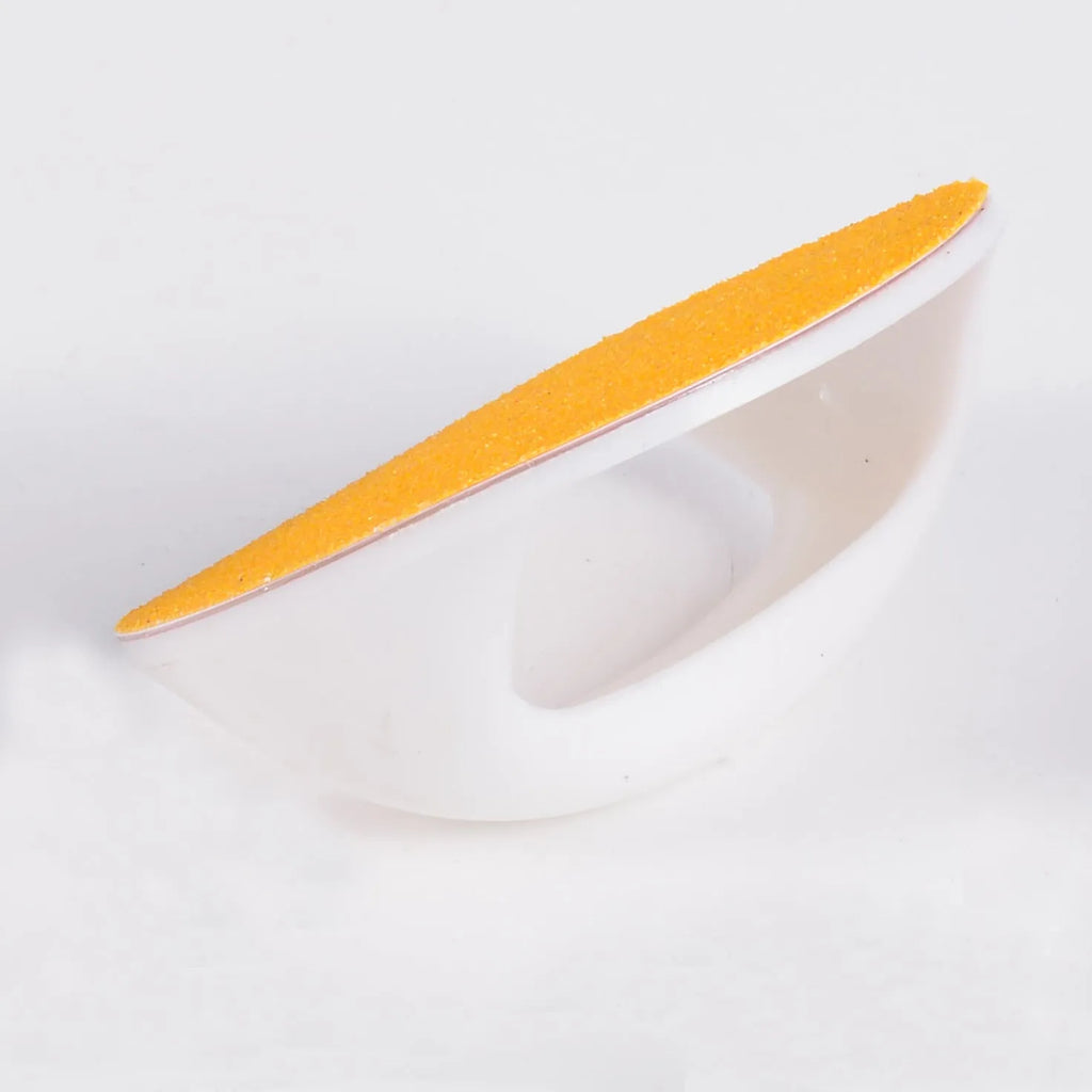 Round blue dog nail file board with ergonomic handle on a table.
