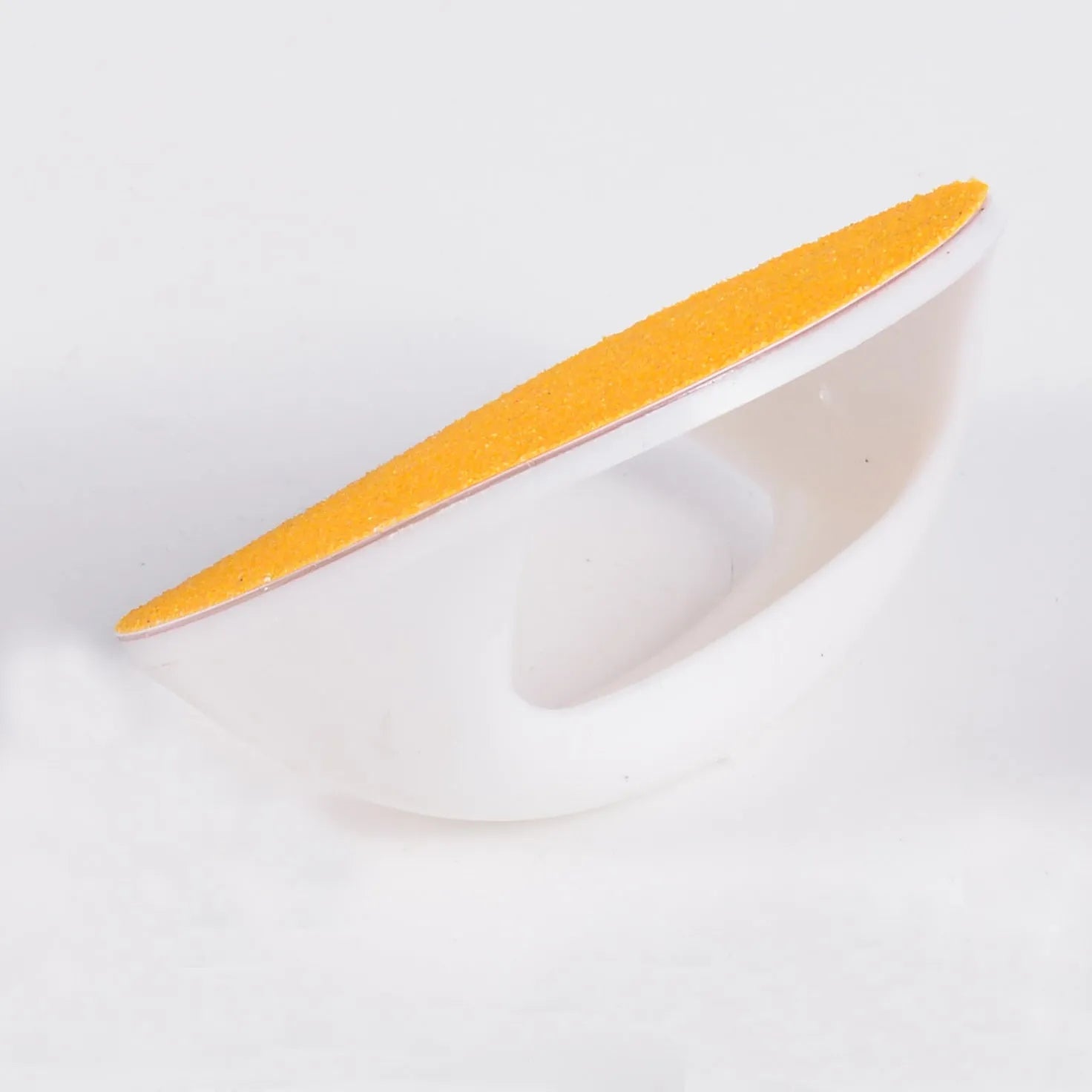 Round blue dog nail file board with ergonomic handle on a table.
