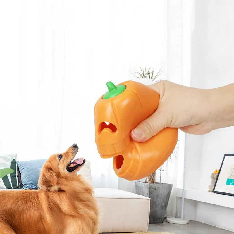 Orange Halloween pumpkin shaped rubber dog toy with a hollow centre for treats.