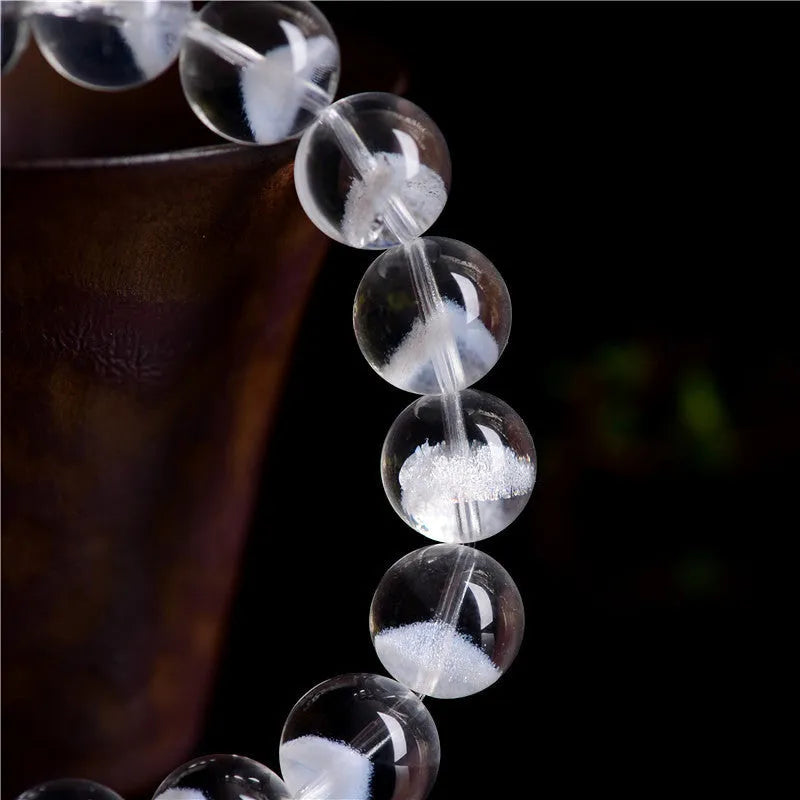 Women's original design white crystal pyramid bracelet with Ruyi charm on wrist.