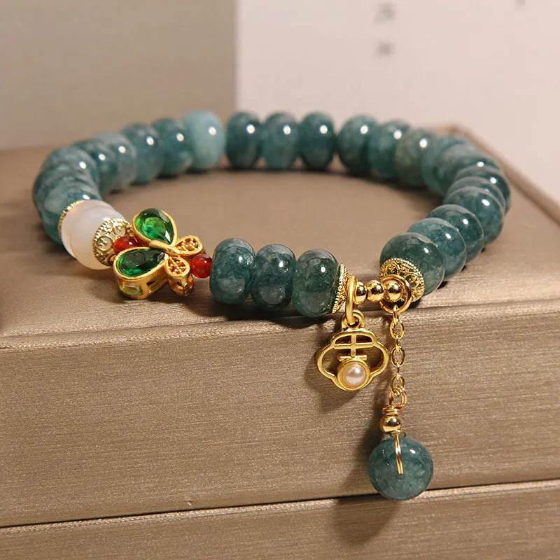 Blue water jade bracelet with white agate abacus beads and butterfly charm
