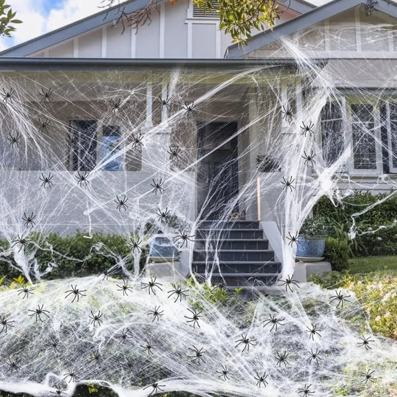 White cotton spider web Halloween decoration props draped across corner with multiple spiders