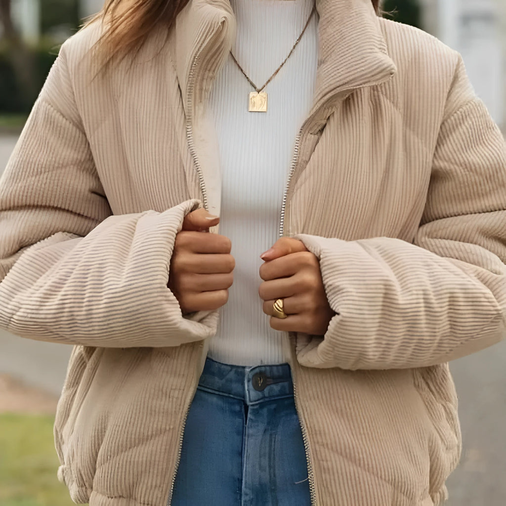 Apricot-coloured women's corduroy jacket with a stand collar and front zip, shown on a hanger.