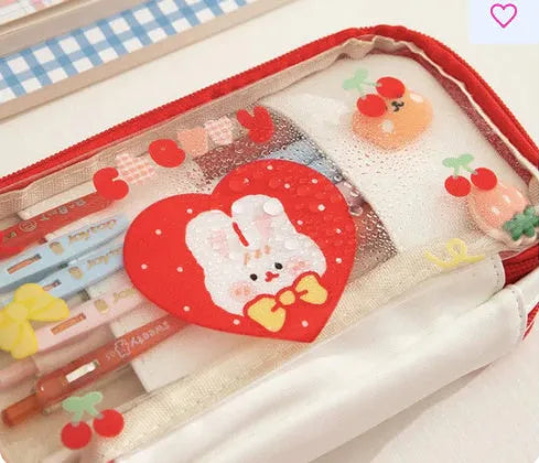 Transparent TPU pencil case with Korean-style pink rabbit design showing visible pens inside