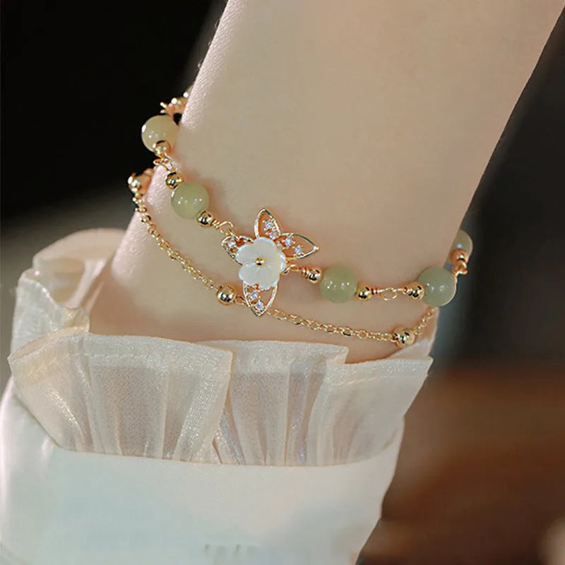 Yellow gold electroplated copper butterfly bracelet with geometric shape and bells of Ireland Hetian jade charm