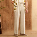 Linen high waist trousers with elasticated waistband in a straight-leg fit on a hanger.