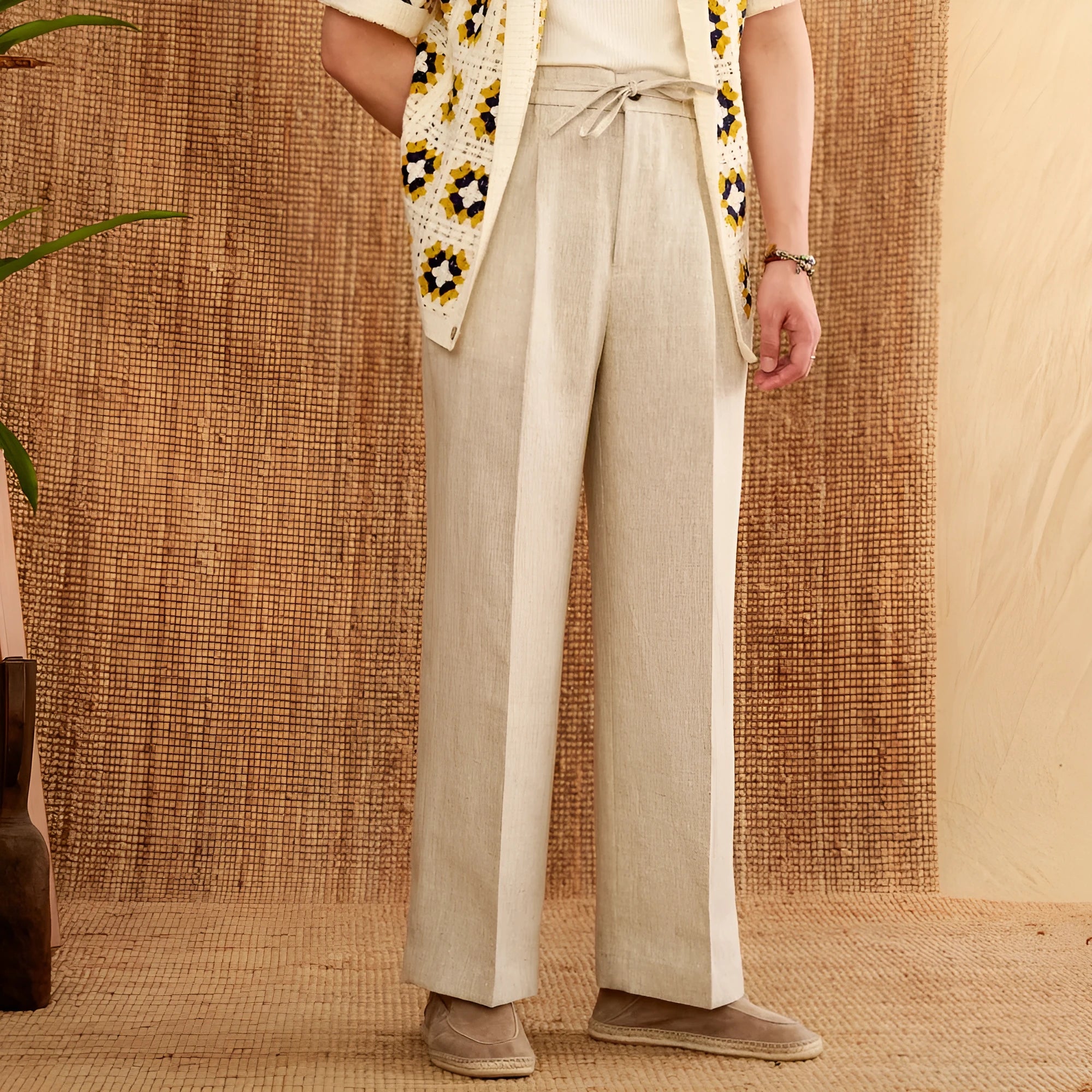 Linen high waist trousers with elasticated waistband in a straight-leg fit on a hanger.