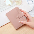 Women's beige lychee pattern short wallet made of PU, showing sewing thread detail and open organiser compartments.
