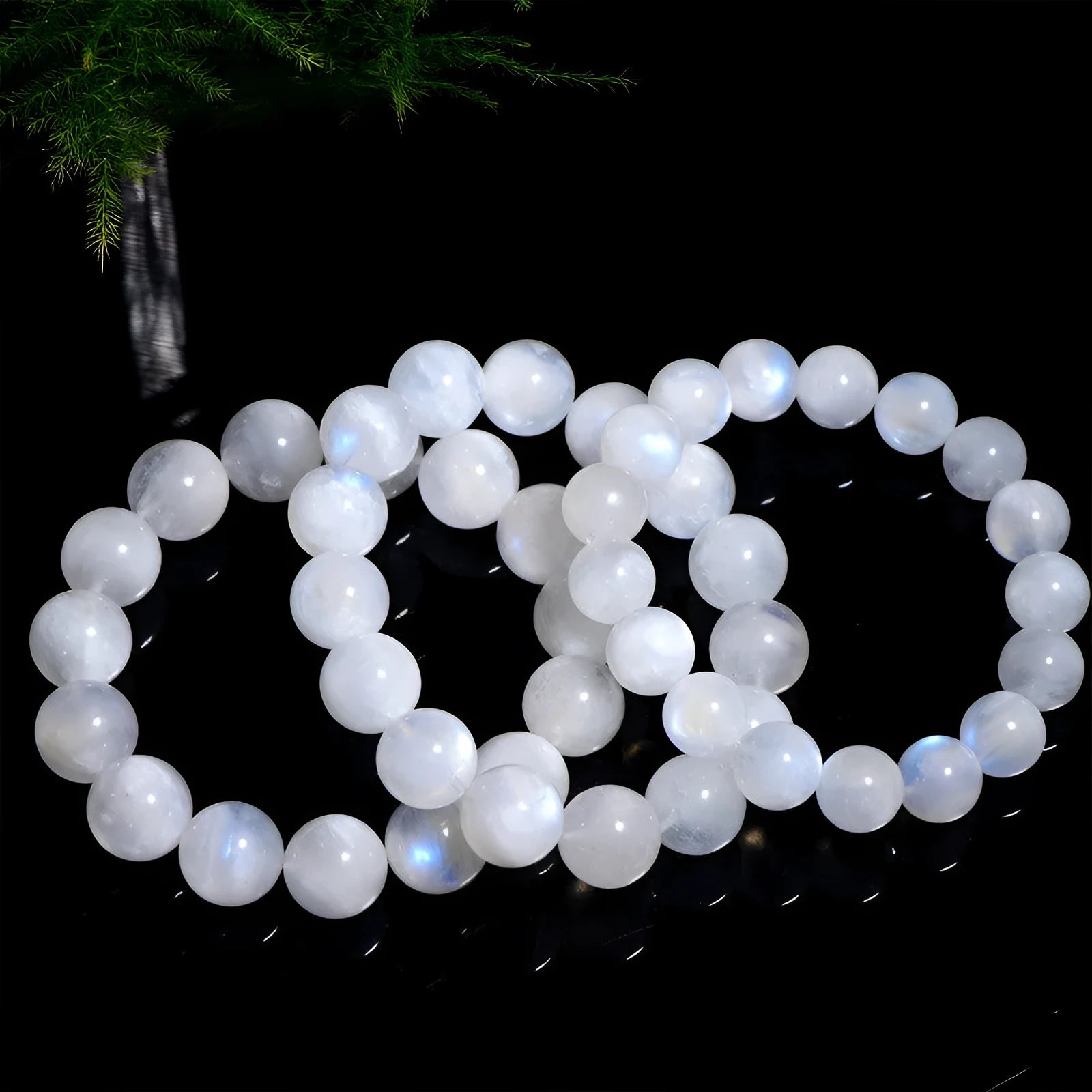 Natural blue moonlight round moonstone bead bracelet on a white background showing polished spherical beads.
